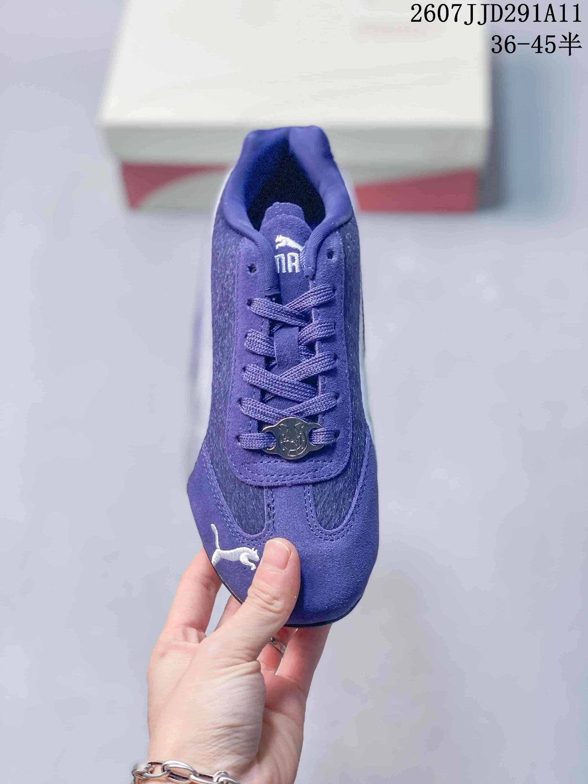 Top view of the purple sneaker showing the laces, decorative lace charm, and white toe branding.