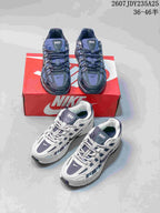 Both dark gray and white Nike P-6000 colorways shown together with a red shoebox.