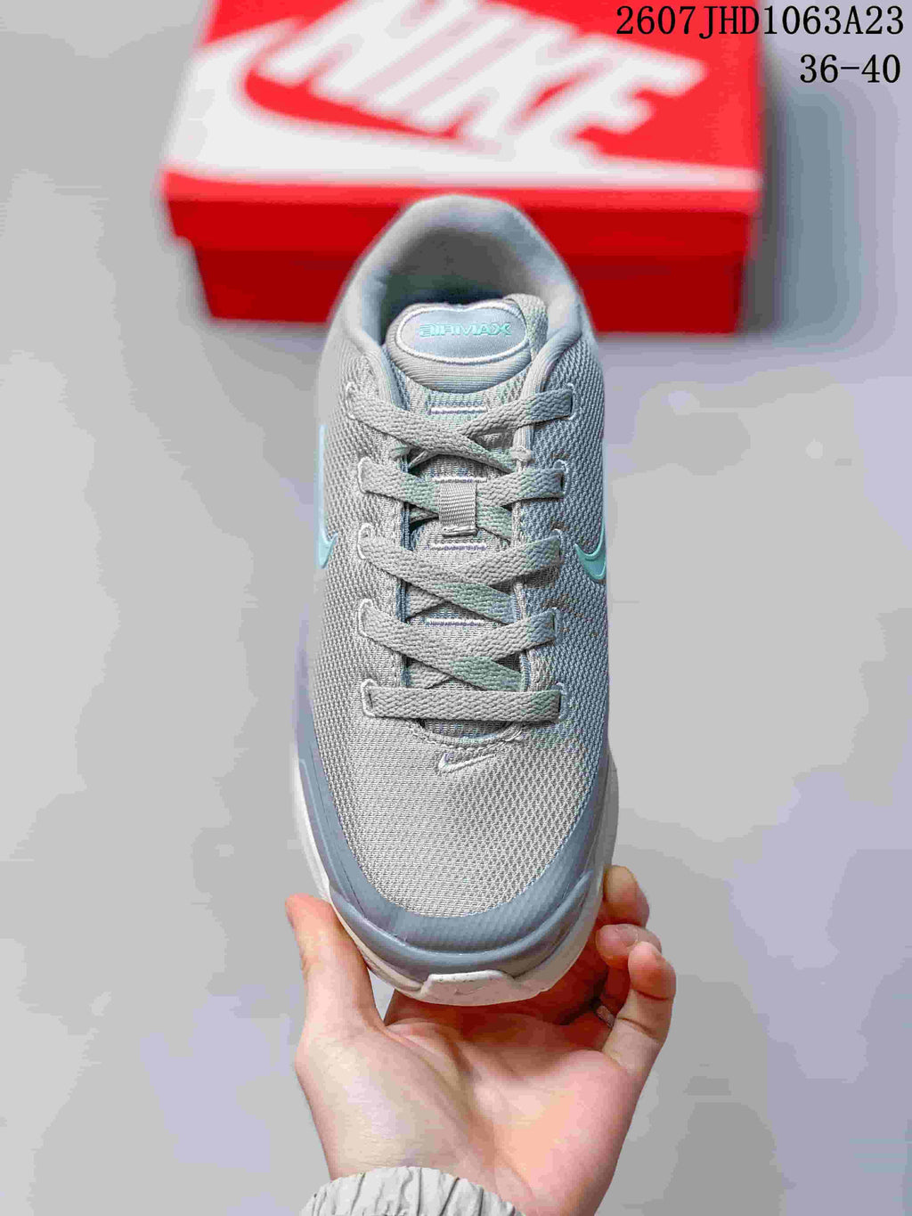 Top view showing the gray lace-up upper, padded tongue, and turquoise side branding.