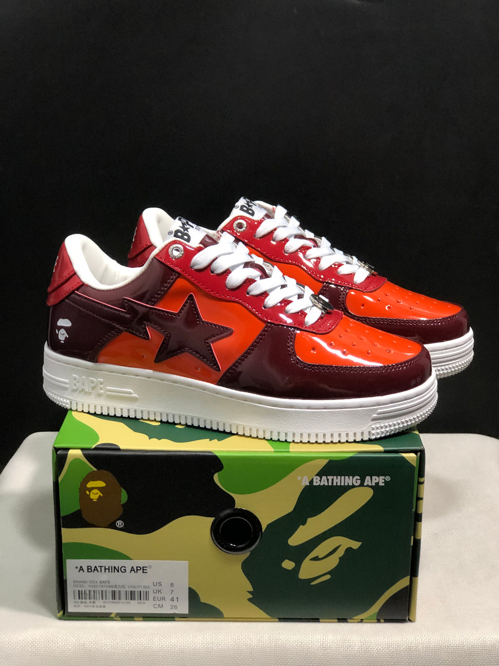 Burgundy and orange Bape Sta sneakers displayed above a branded shoe box; the box label shows EU 41, US 8, UK 7 and CM 26.