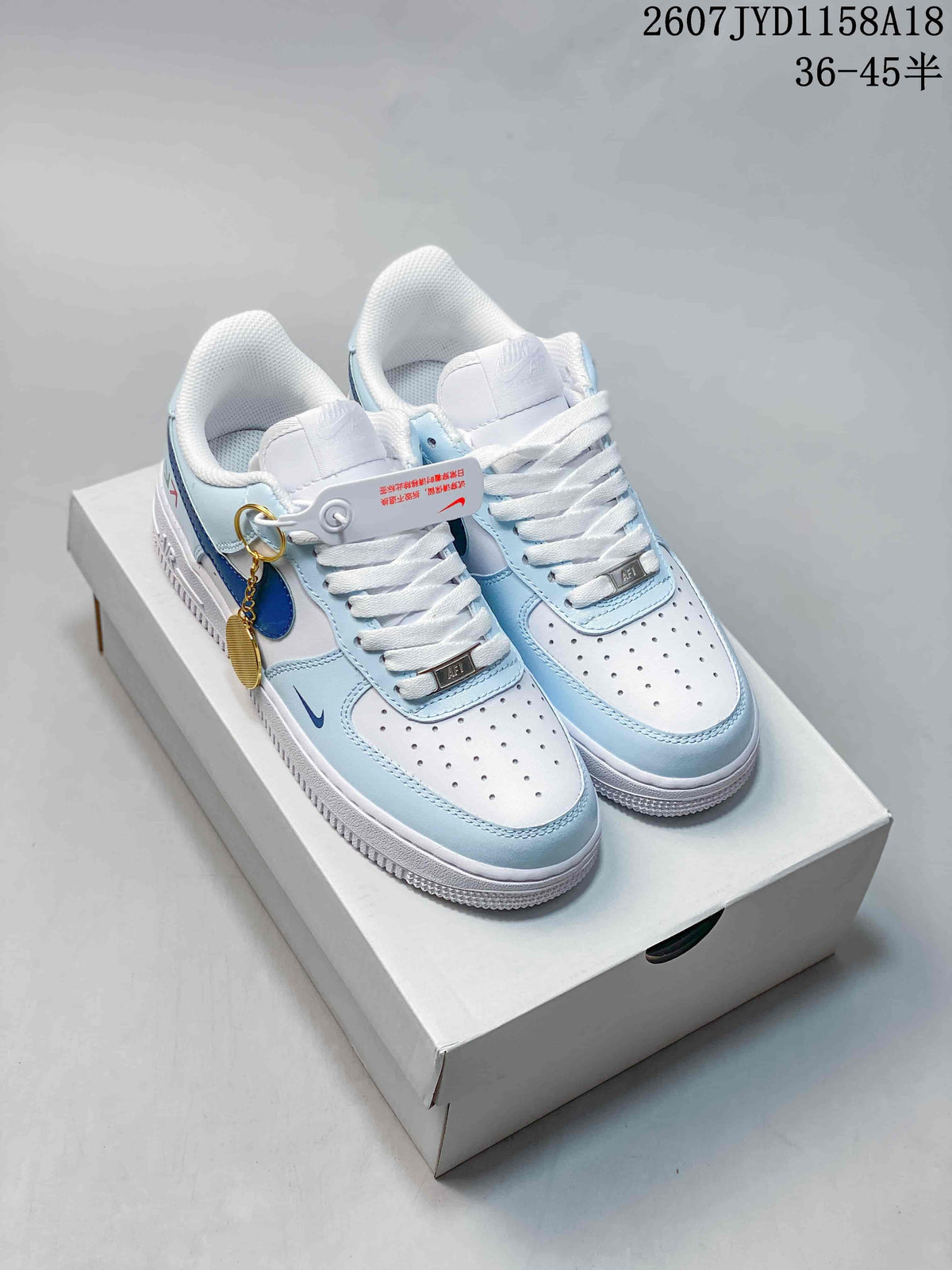 Pair of white and light blue Nike Air Force 1 '07 low-top sneakers displayed on a shoebox, with a visible size range marking of 36–45.