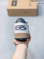 Rear view of the sneaker showing the white heel panel, raised graphic lettering, and layered gum-colored and dark outsole.