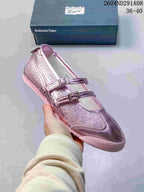 Angled side view of the pink Onitsuka Tiger sneaker showing the metallic upper, two buckle straps, and pink outsole.