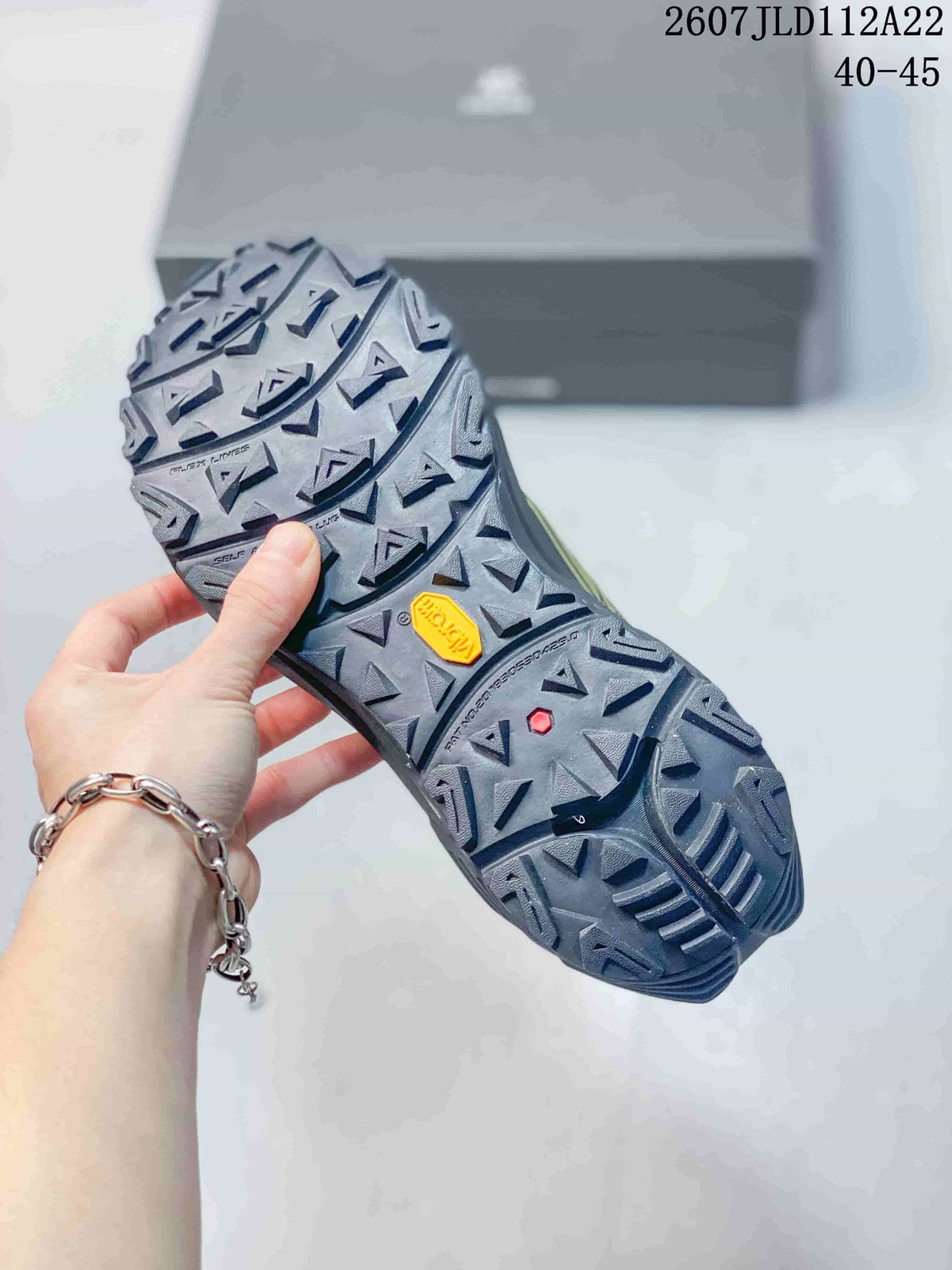 Outsole view showing a dark lugged tread pattern, Vibram branding, and the image text 2607JLD112A22 and 40–45.