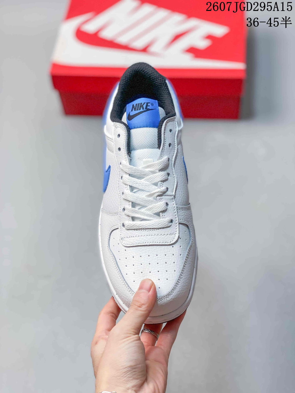 Top view showing the perforated white toe box, white laces, blue tongue label, and black padded collar.