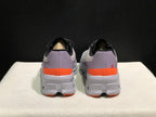 Rear view of gray On Cloud X sneakers with lavender-gray heel panels and orange bands.