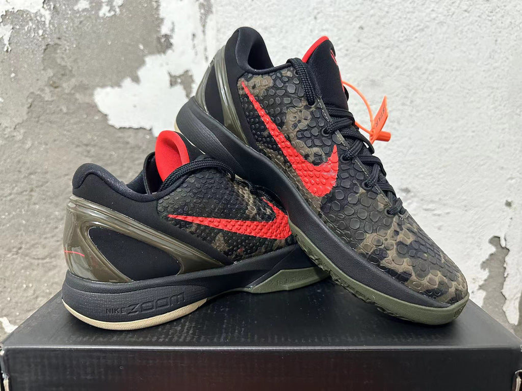 Nike Kobe camouflage basketball shoes displayed together, showing red Swooshes and olive-toned outsoles