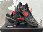 Nike Kobe camouflage basketball shoes displayed together, showing red Swooshes and olive-toned outsoles