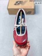 Top view of the red sneaker showing the white lace-up closure, contrasting trim, and dark insole.