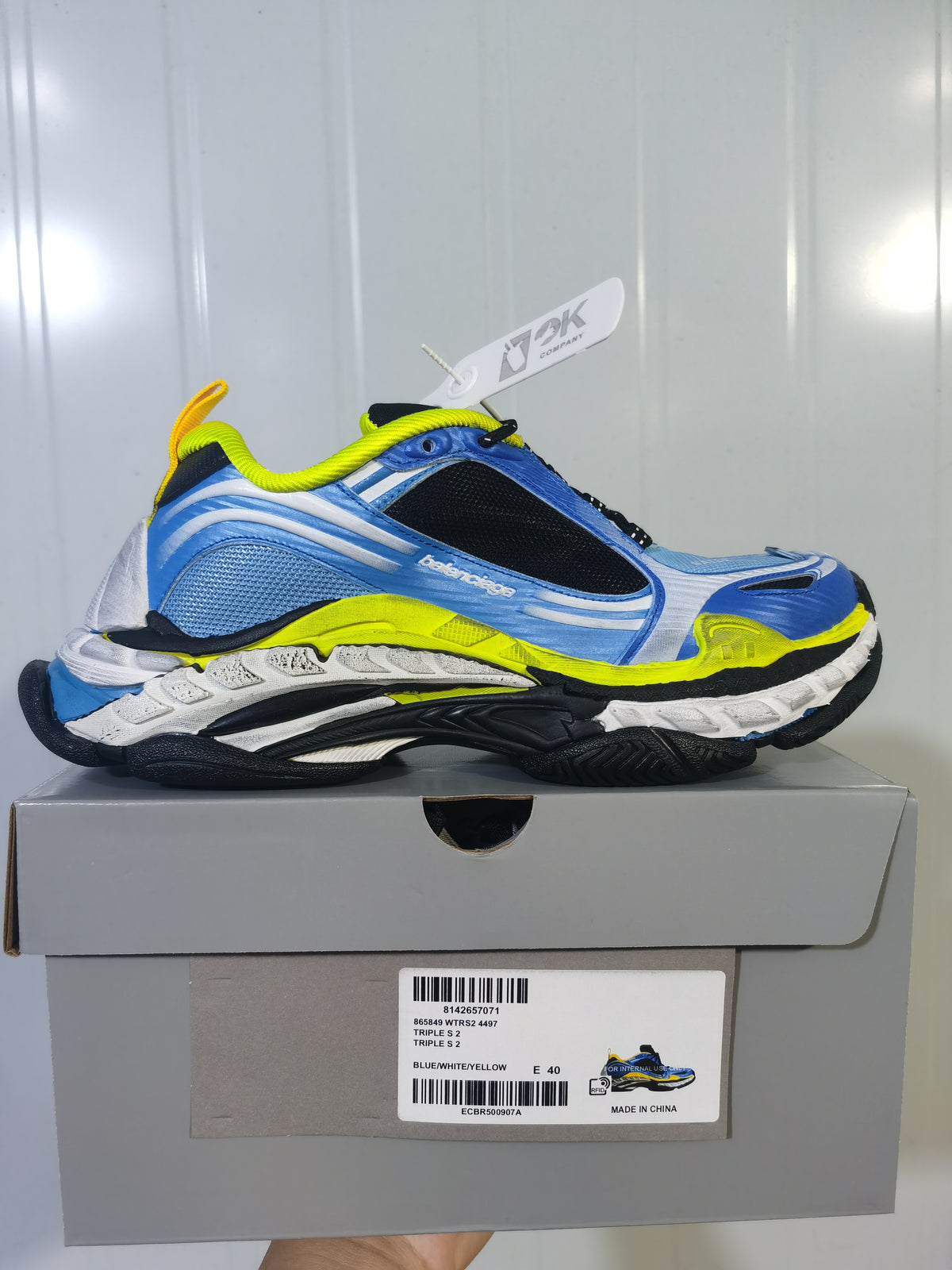 Balenciaga Triple S 2 sneaker displayed on its box, showing the layered outsole and box label with blue/white/yellow color information and EU size 40.