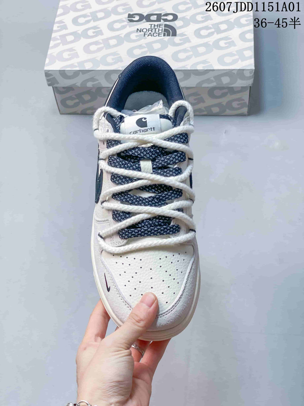 Top view showing perforated toe panels, navy patterned tongue fabric, and white laces