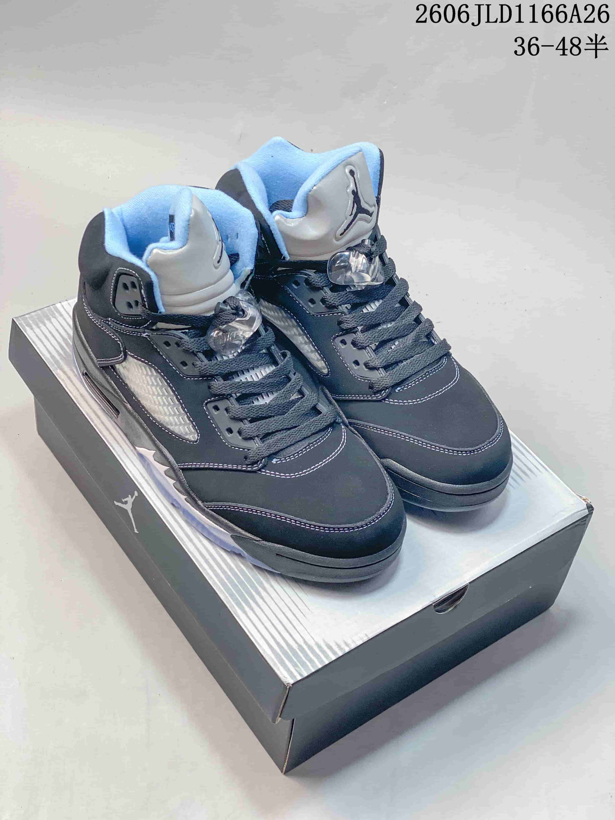 Pair of dark Jordan Air Jordan 5 high-top sneakers with light blue accents, shown on a shoebox.
