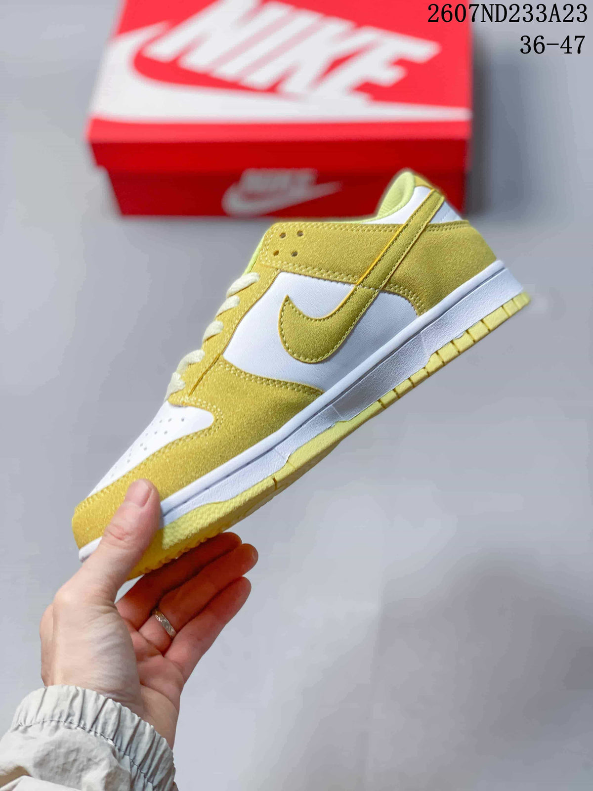 Side profile showing the yellow and white layered upper, Swoosh branding, and low-top silhouette.