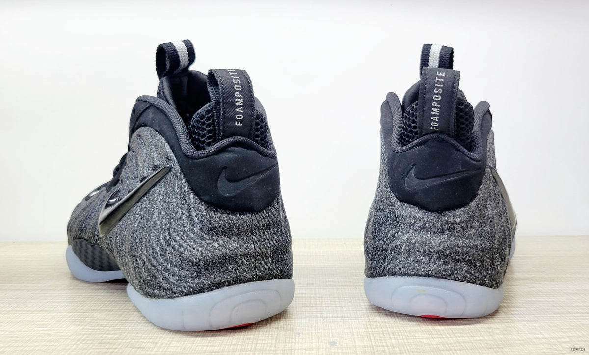 Rear view of black and grey Nike Air Foamposite Pro Fleece high-top sneakers