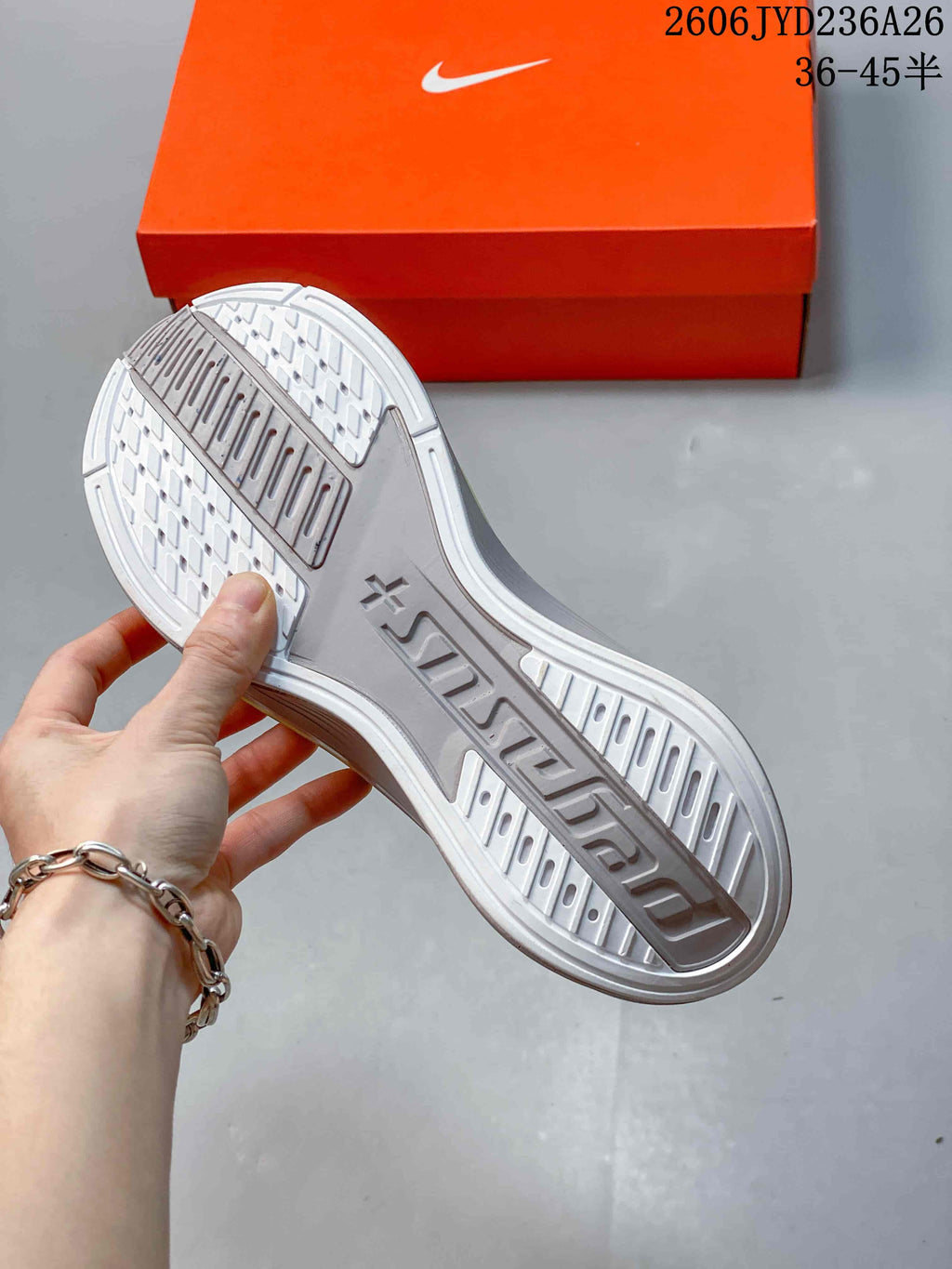 Underside of a Nike Pegasus Plus shoe showing the patterned outsole.