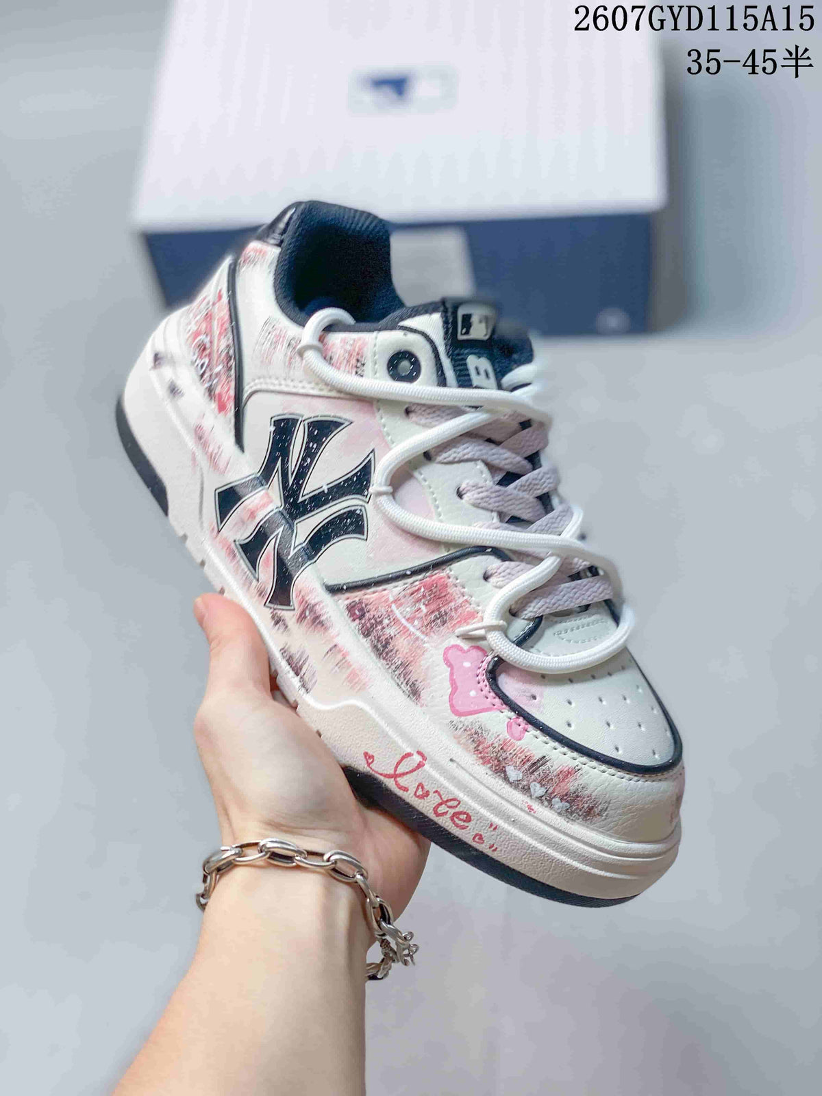 Angled side view of the MLB sneaker showing the NY-style side logo, pink graphics and raised white sole.