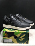 Black and white Bape Sta sneakers displayed on a branded camouflage shoe box.