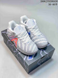 Pair of white and gray Nike Ja 3 basketball shoes with blue and pink accents, shown on the box.