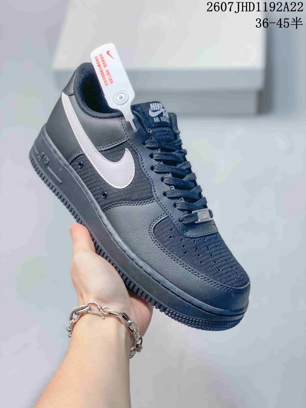 Angled side view highlighting the black upper, white Swoosh and layered rubber sole.