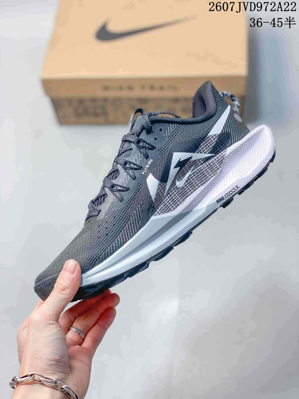 Side profile showing the mesh-style upper, Nike branding, white midsole, and trail outsole.