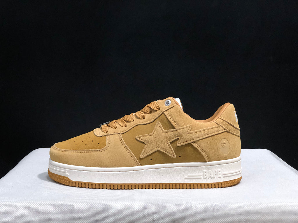 Side profile of a wheat Bape Sta sneaker showing the tonal star side panel, white midsole and gum outsole.