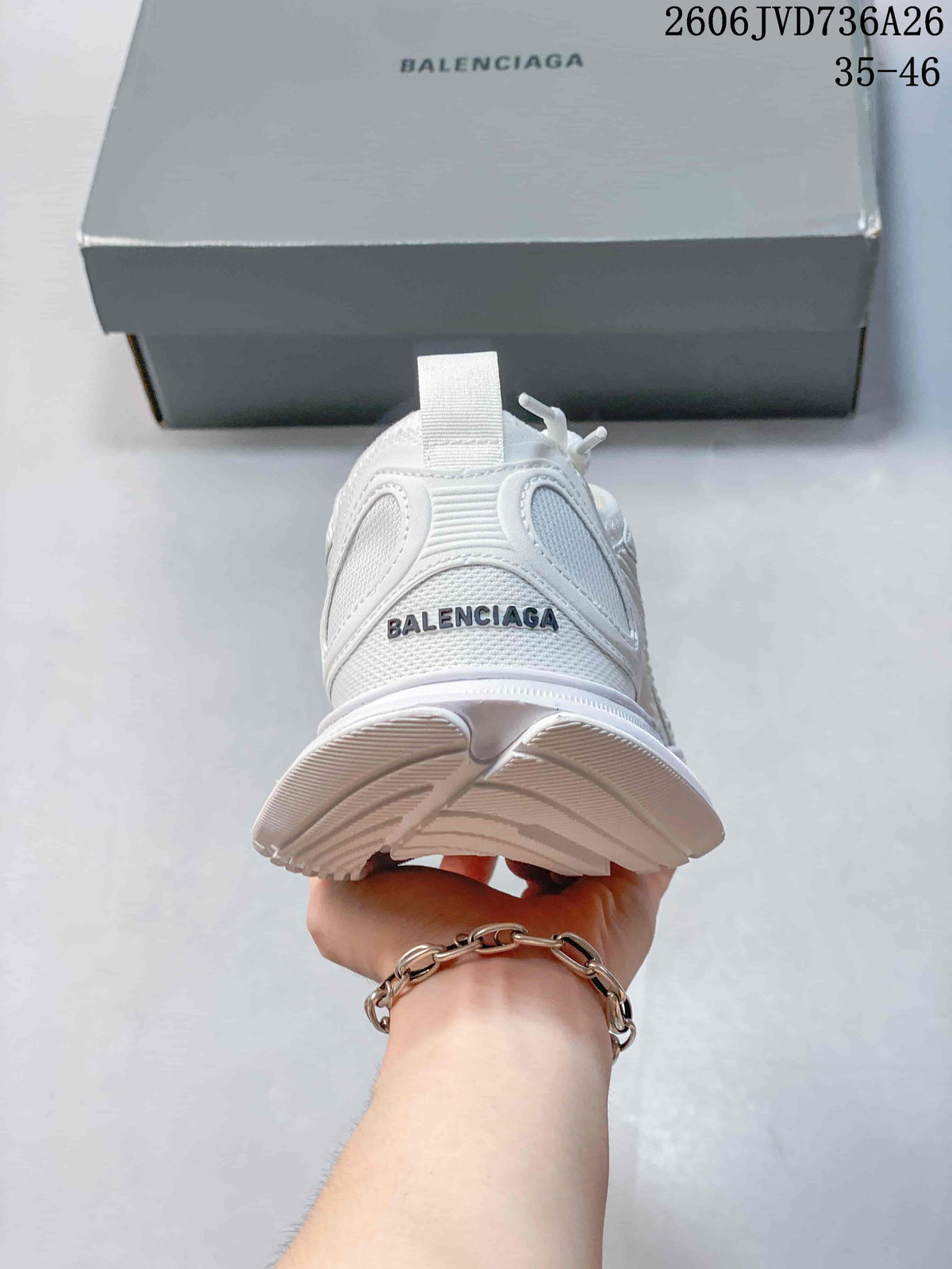 Rear view of a white sneaker with a heel pull tab and visible branding.