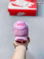 Rear view showing the pink heel and red Nike logo detail.