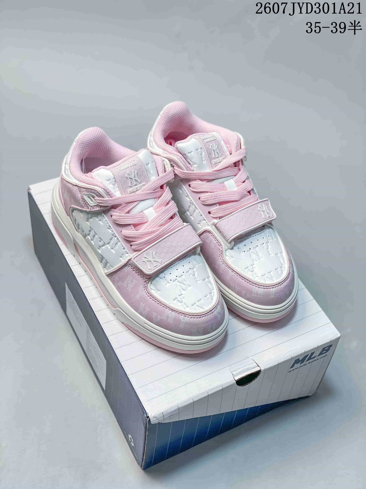Pair of pink and white MLB New York Yankees high-top sneakers displayed on a shoebox.