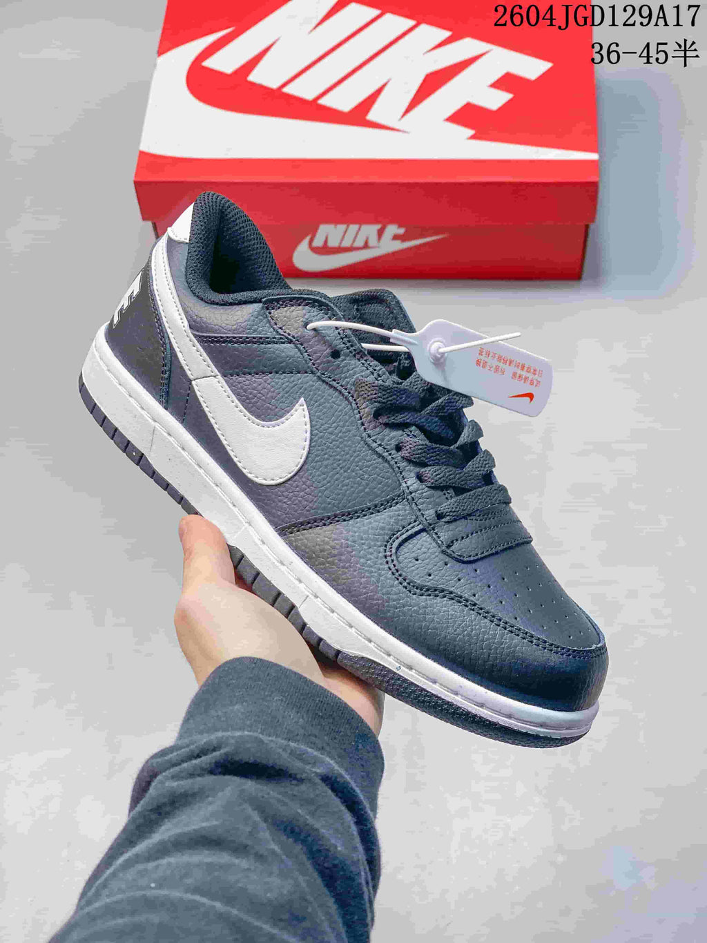 Close-up of a dark blue-gray low-top sneaker with a white Swoosh