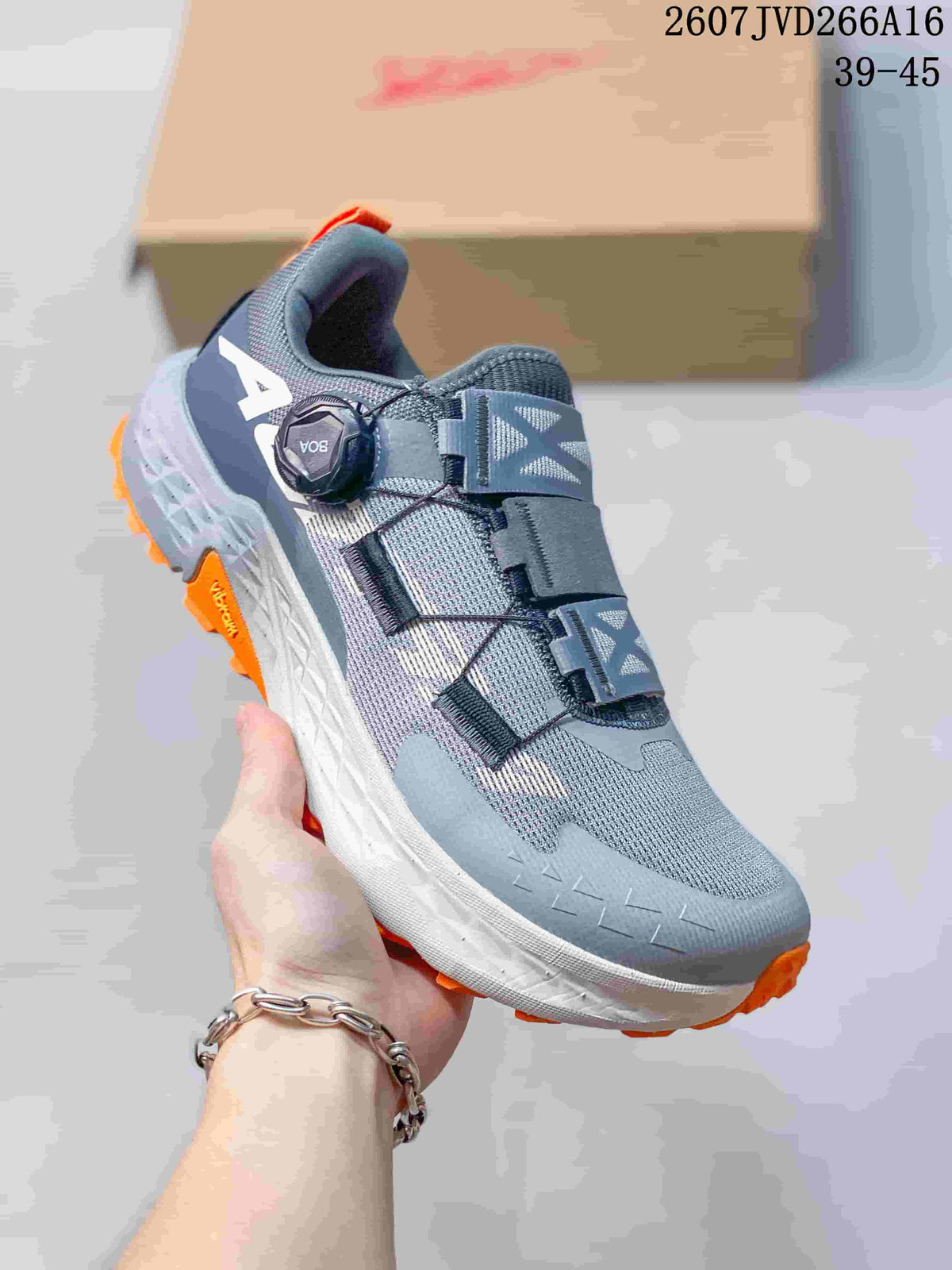 Close-up of a gray Altra TIMP 5 BOA trail running shoe showing the BOA dial, layered upper, and orange outsole accents.