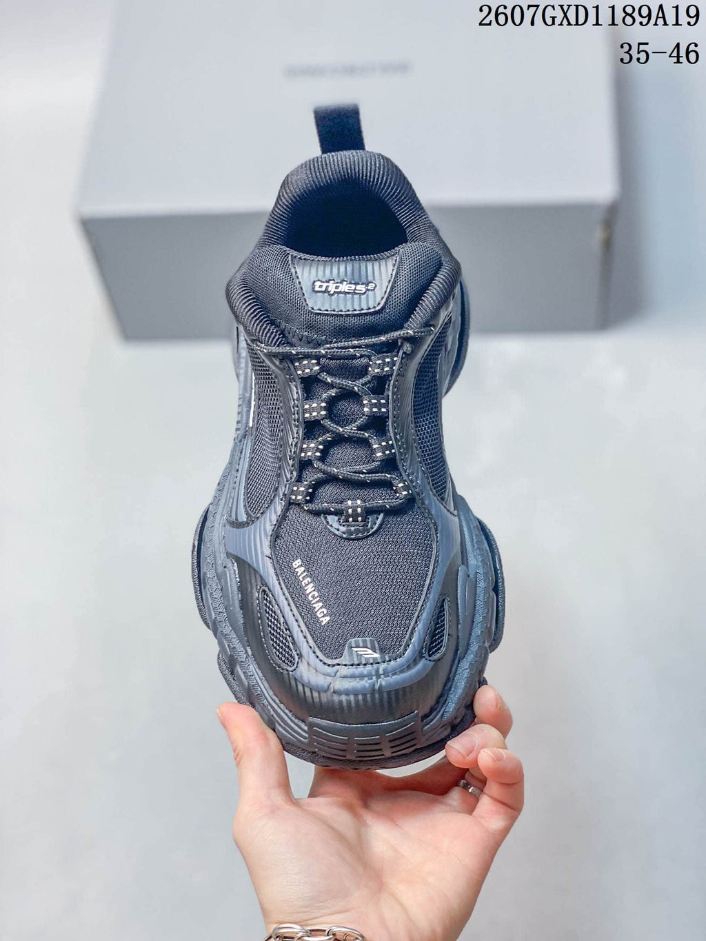 Front view of a Balenciaga Triple S.2 sneaker with lace-up closure, mesh panels, and toe branding.