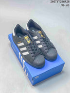Pair of black adidas sneakers with white stripes and textured toe caps displayed on a blue adidas shoe box; overlaid text shows style code 2607YY296A26 and size range 36–45.