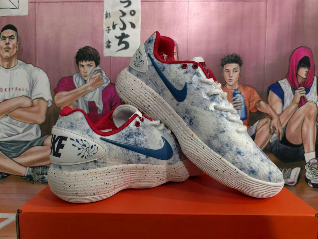 Pair of Nike shoes showing the blue swooshes, mottled uppers, red collars, and speckled soles.