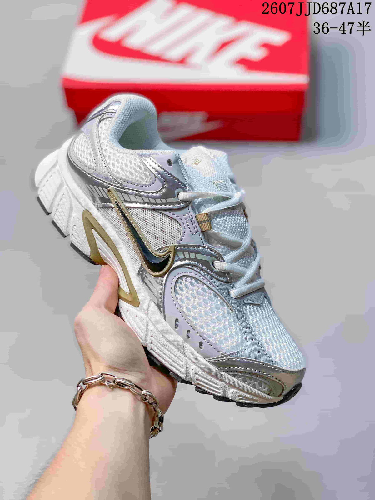 White Nike V5 RNR sneaker with pale lavender and gold-toned accents.