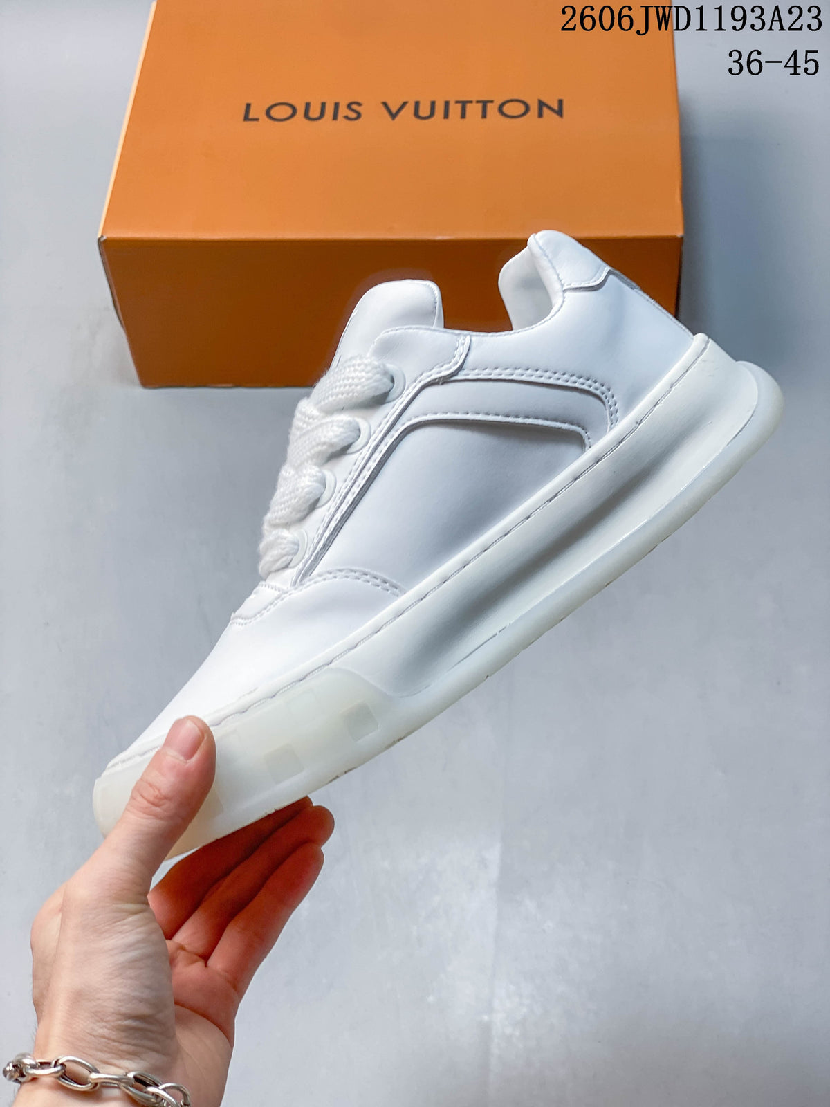 Side profile of a white low-top sneaker with stitched panels and a chunky sole
