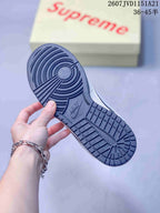 Close-up of the dark rubber outsole showing circular and grid traction sections.