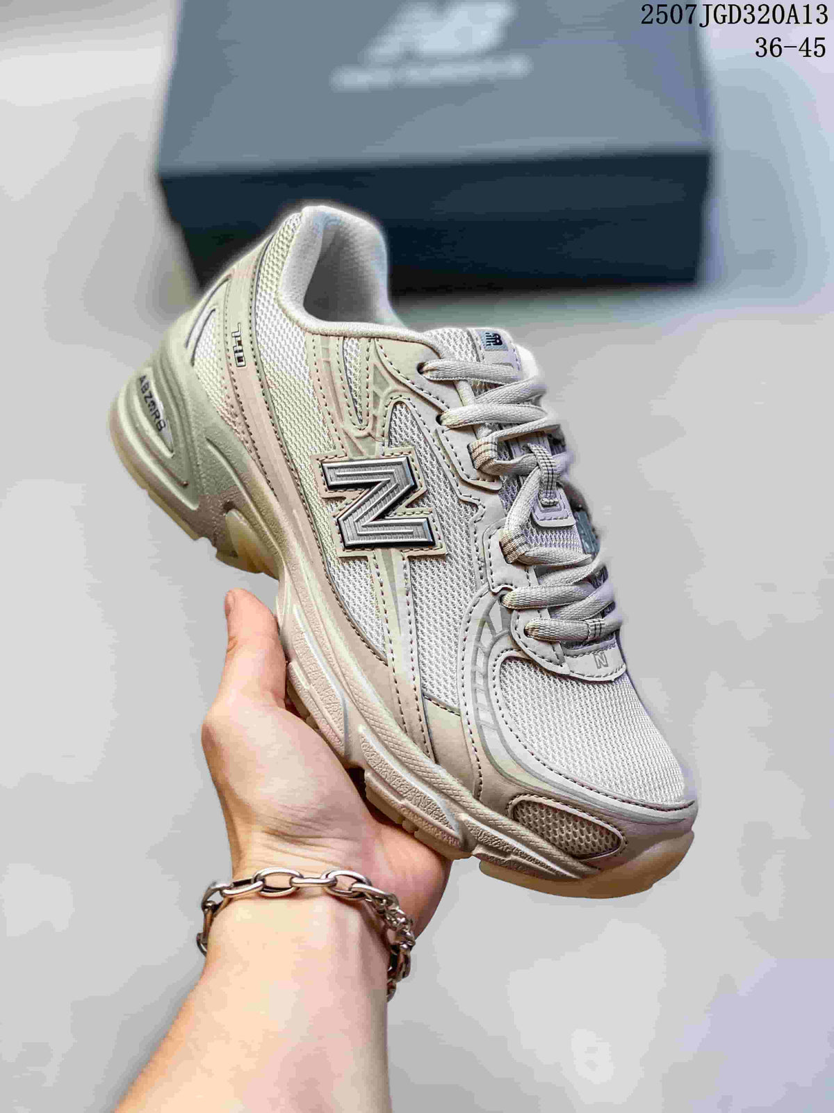 Angled side view of the cream New Balance 740 sneaker showing the N logo, mesh sections and cream outsole.