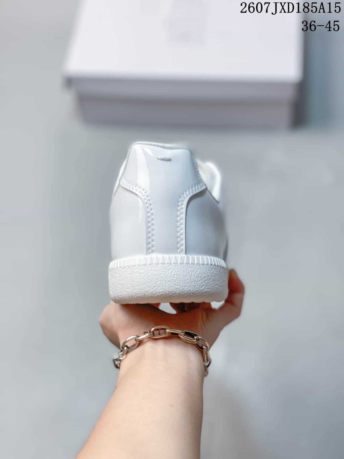 Rear view of the white sneaker showing the heel and outsole
