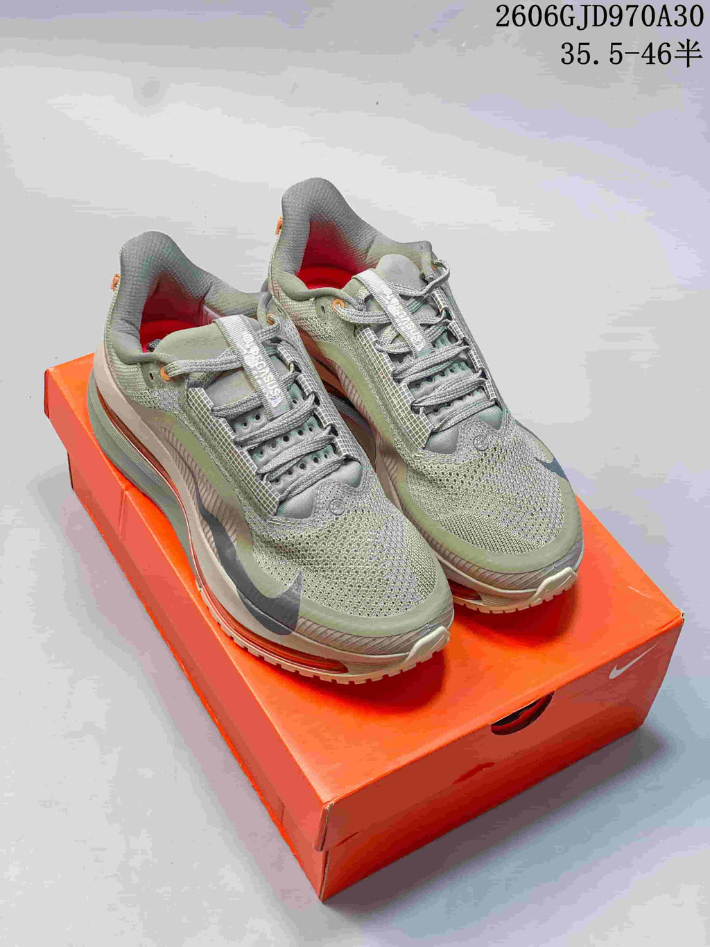 Olive-grey Nike Air Zoom Pegasus Premium shoes on an orange box; image overlay shows style code JD970A30 and a size range.