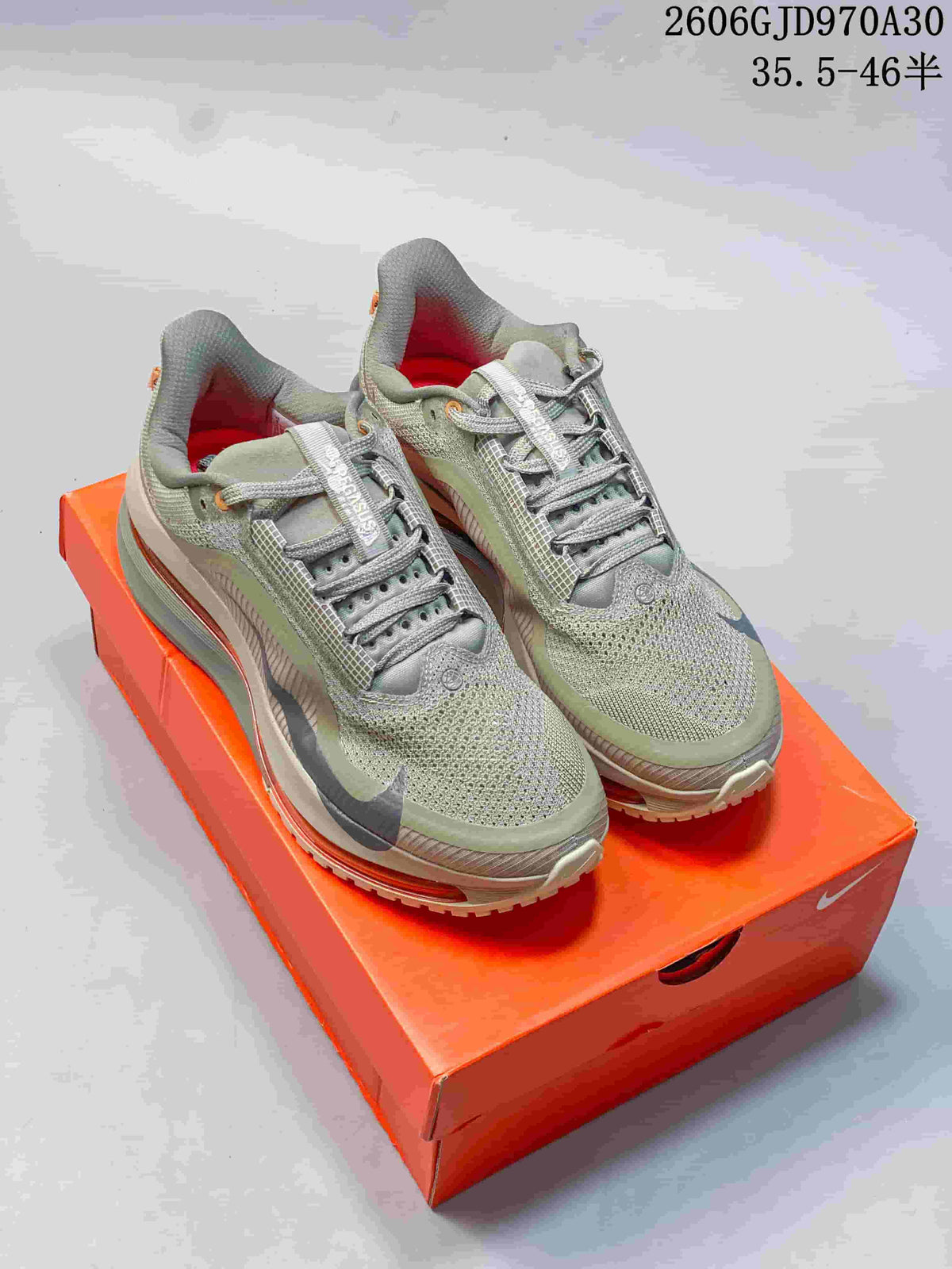 Olive-grey Nike Air Zoom Pegasus Premium shoes on an orange box; image overlay shows style code JD970A30 and a size range.