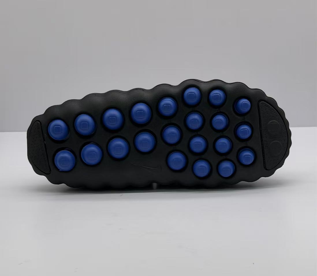 Outsole view showing multiple blue rounded pods across the black sole.