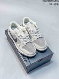 Pair of white and grey low-top sneakers displayed on a dark shoebox; Nike and Louis Vuitton branding are visible.