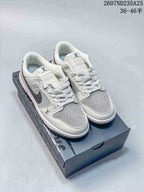 Pair of white and grey low-top sneakers displayed on a dark shoebox; Nike and Louis Vuitton branding are visible.