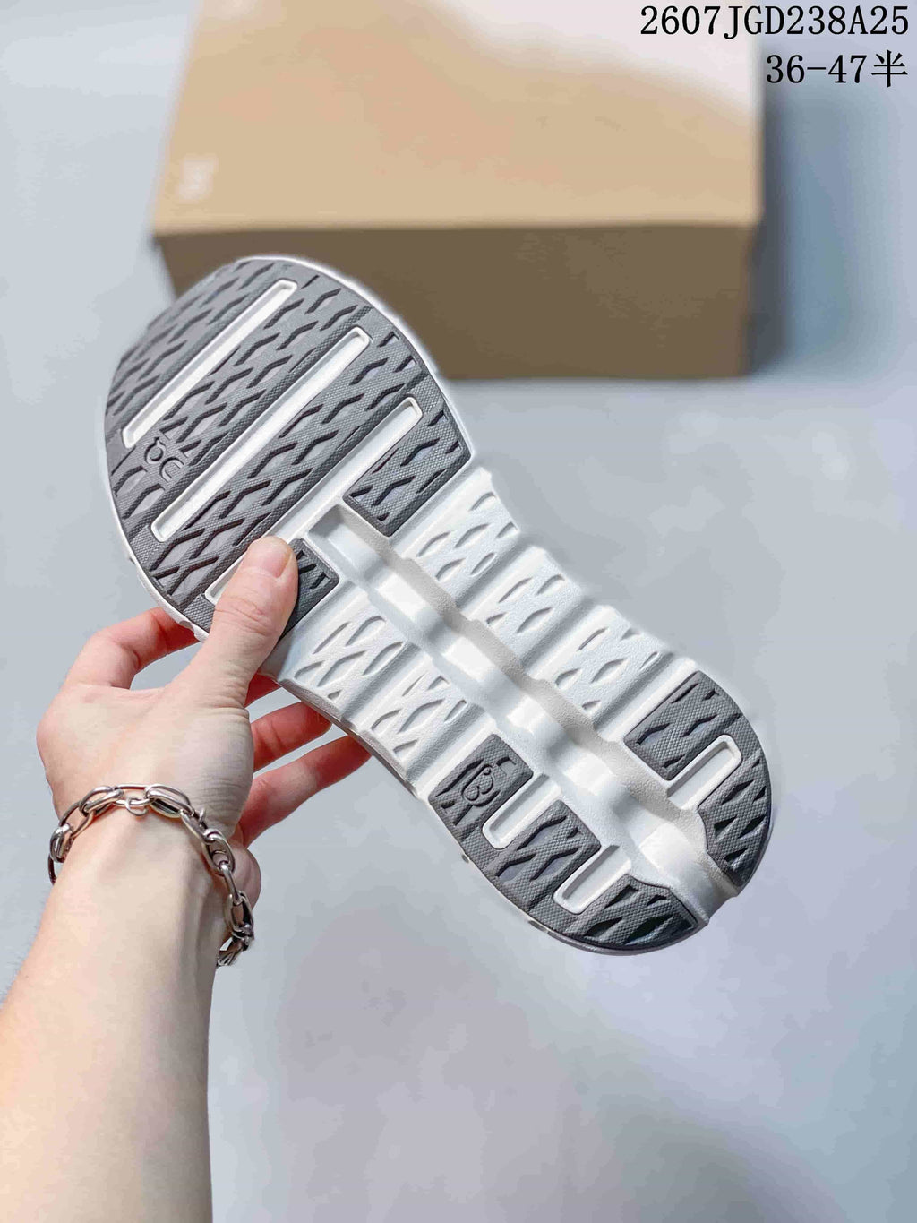 Close view of the outsole showing a segmented tread pattern with dark gray sections.