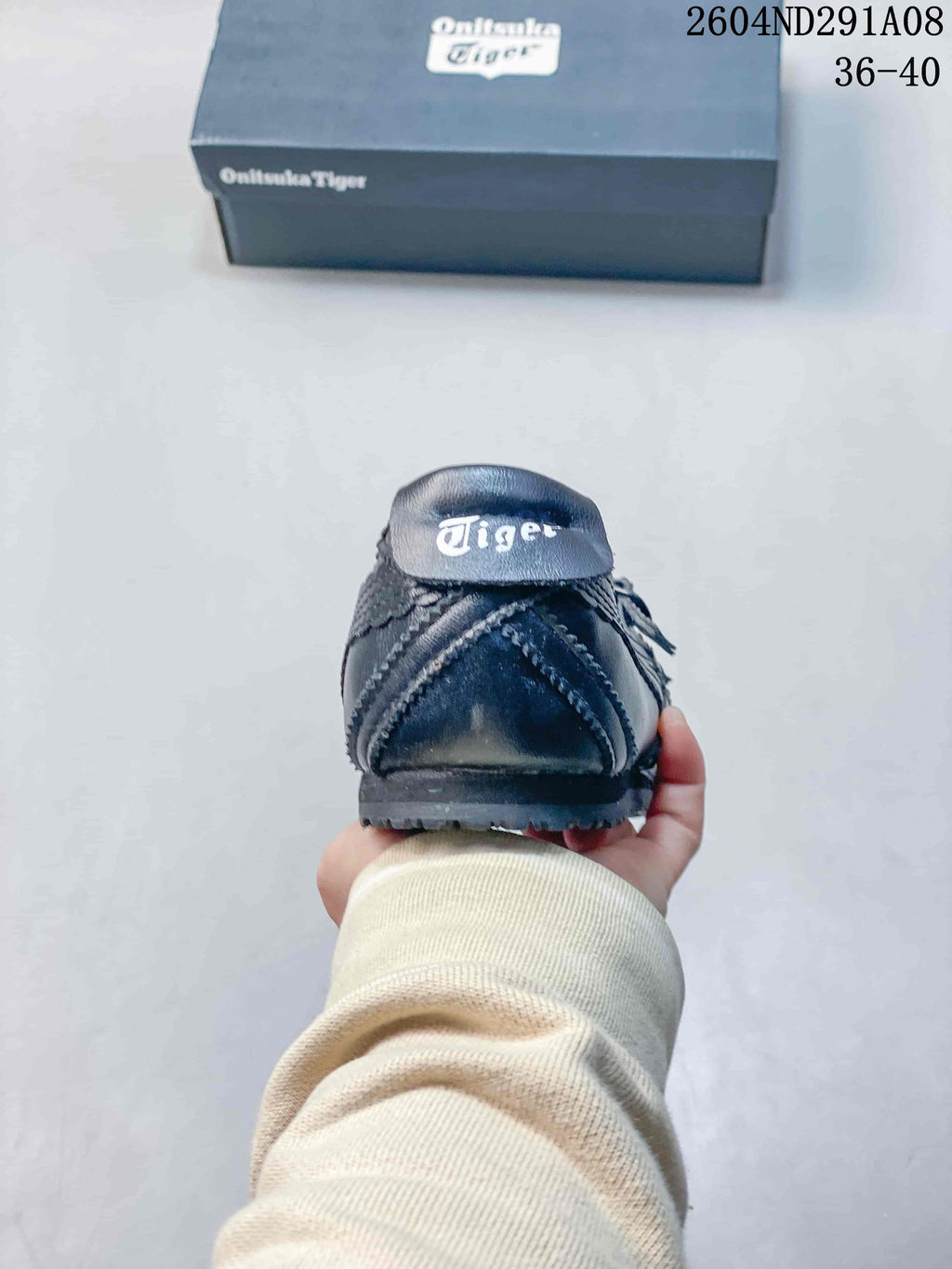 Rear view of the black sneaker showing the heel branding, outsole, and Onitsuka Tiger box.