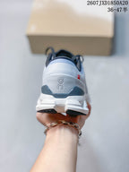 Rear view of the sneaker showing the padded collar, heel branding, and white segmented midsole.