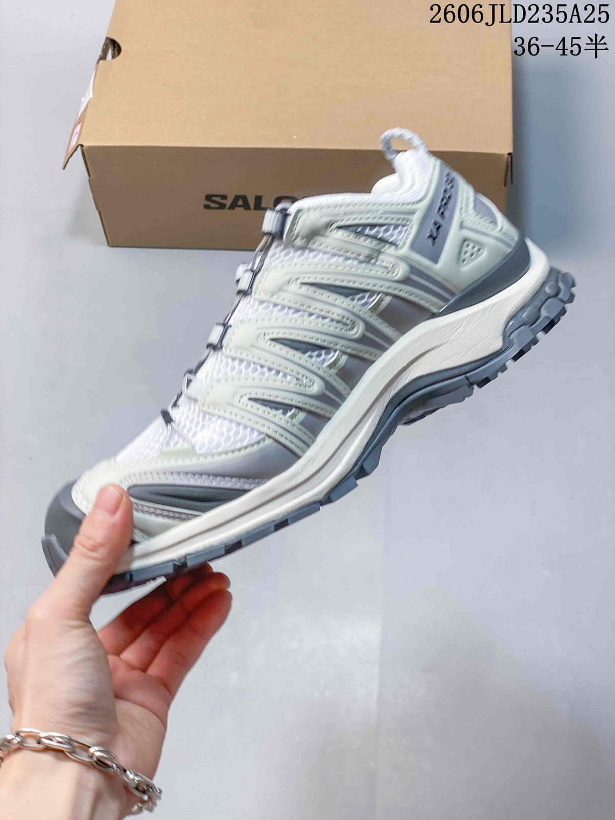 Side view of the white and gray trail shoe