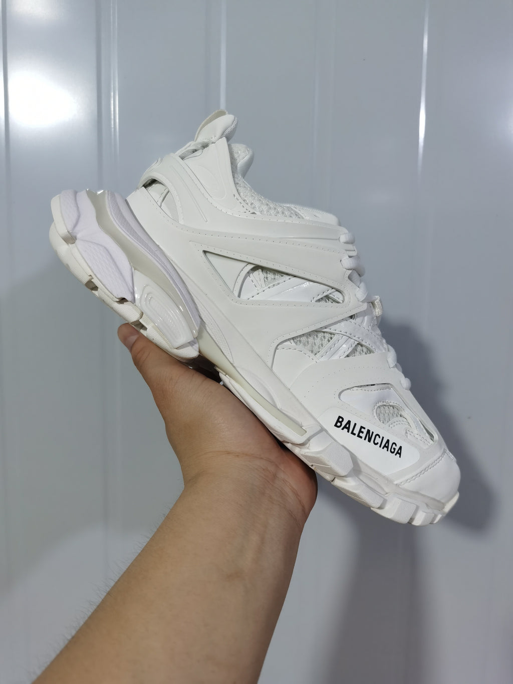 Close angled view of the white Balenciaga Track sneaker showing the open-panel upper, layered sole and toe branding.