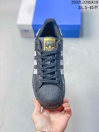Front view showing the black laces, gold tongue label, and textured shell toe.