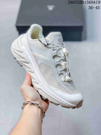 Close side view of a white KAILAS trail shoe showing the mesh-style panels, layered overlays, quick-lacing system and lugged outsole.